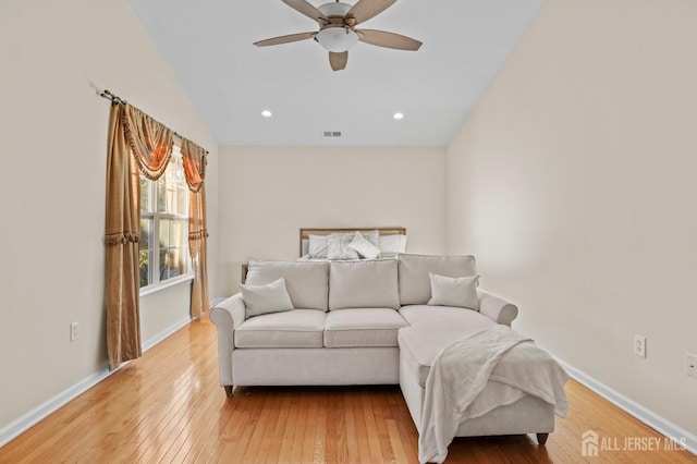 bedroom with ceiling fan, hardwood / wood-style flooring, and lofted ceiling