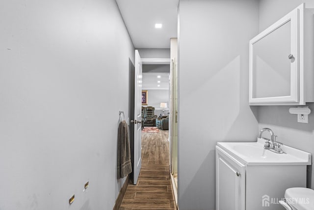 59 Mckinley Ave, Colonia, NJ 07067 - laundry room with dark wood-style flooring, a sink, and baseboards