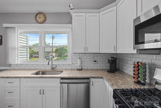 59 Mckinley Ave, Colonia, NJ 07067 - kitchen with appliances with stainless steel finishes, a sink, white cabinetry, tasteful backsplash, and light stone countertops