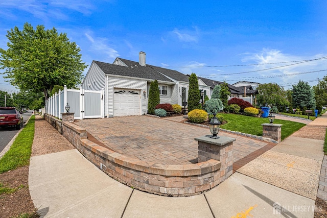 59 Mckinley Ave, Colonia, NJ 07067 - view of front of property with an attached garage, a chimney, and driveway