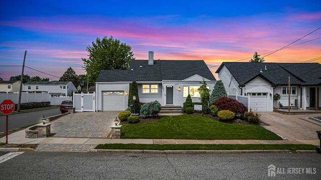 59 Mckinley Ave, Colonia, NJ 07067 - view of front of home with decorative driveway, an attached garage, a chimney, a gate, and entry steps