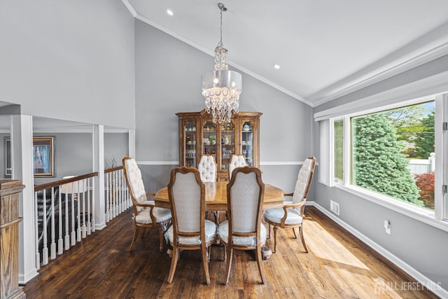 59 Mckinley Ave, Colonia, NJ 07067 - dining space with lofted ceiling, a chandelier, wood finished floors, baseboards, and crown molding