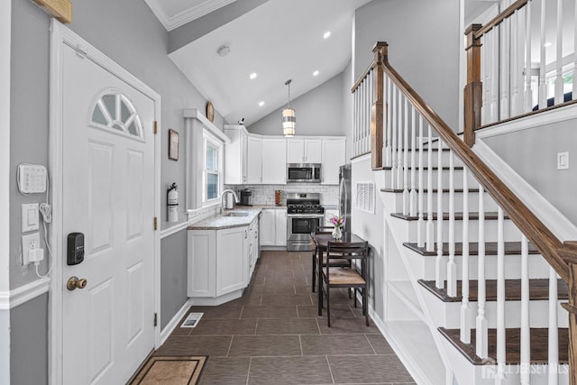 59 Mckinley Ave, Colonia, NJ 07067 - kitchen featuring stainless steel appliances, white cabinetry, decorative backsplash, a sink, and recessed lighting