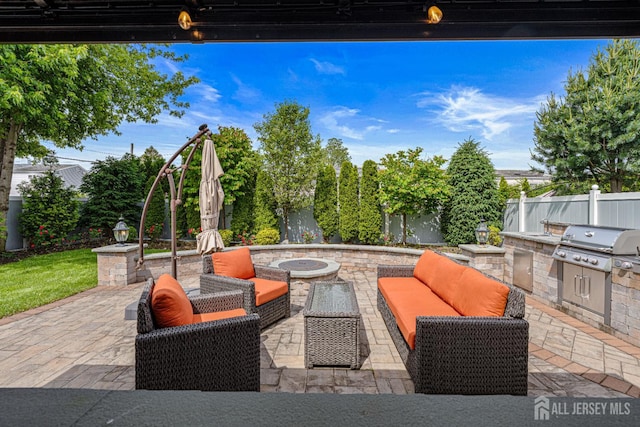 59 Mckinley Ave, Colonia, NJ 07067 - fenced backyard with a patio area, an outdoor living space with a fire pit, and a sink