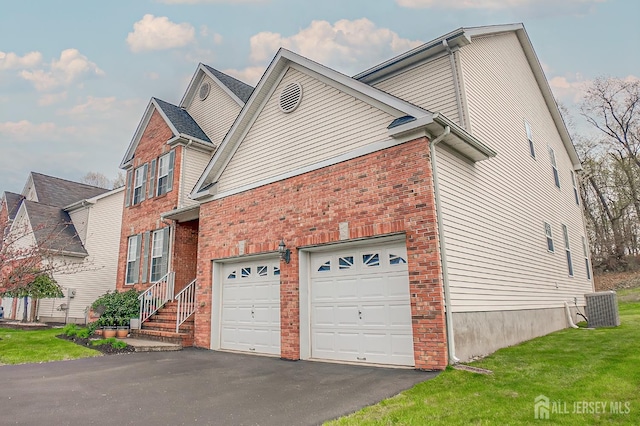 47 Bay Hill Blvd, Monroe, NJ 08831 - view of side of home featuring driveway, brick siding, a yard, and an attached garage