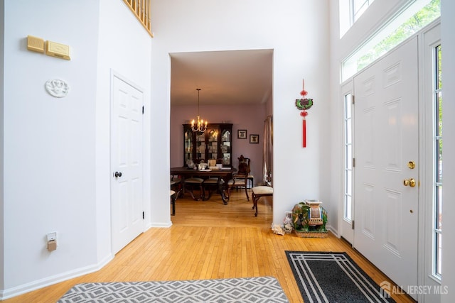 7 Sequoia Dr, South Brunswick, NJ 08810 - entryway featuring a chandelier, light wood-style floors, a high ceiling, and baseboards