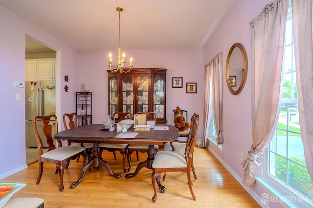 7 Sequoia Dr, South Brunswick, NJ 08810 - dining area featuring a chandelier, light wood-style floors, and baseboards