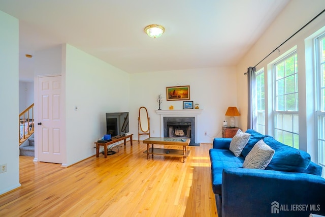 7 Sequoia Dr, South Brunswick, NJ 08810 - living room with light wood finished floors, a fireplace, and stairway