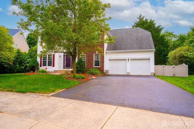7 Sequoia Dr, South Brunswick, NJ 08810 - view of front of home featuring an attached garage, asphalt driveway, a gate, and brick siding