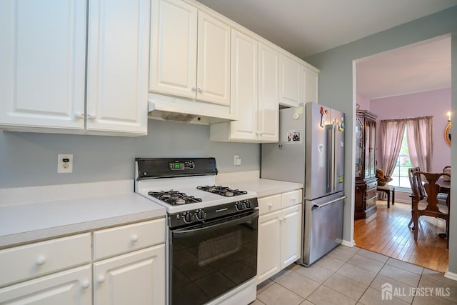 7 Sequoia Dr, South Brunswick, NJ 08810 - kitchen with range with gas cooktop, under cabinet range hood, freestanding refrigerator, and white cabinets
