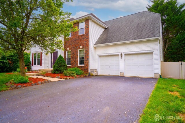 7 Sequoia Dr, South Brunswick, NJ 08810 - view of front facade with a garage, driveway, and brick siding