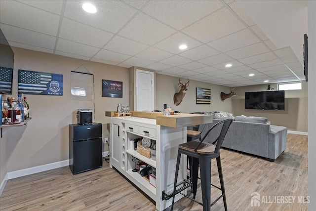 1329 New Brunswick Ave, Middlesex, NJ 07080 - bar area with light wood-type flooring, baseboards, freestanding refrigerator, a paneled ceiling, and recessed lighting