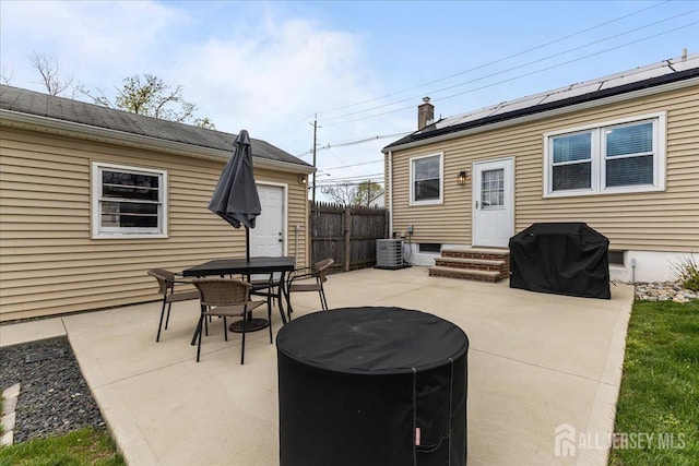 view of patio / terrace featuring grilling area, central air condition unit, fence, and outdoor dining space