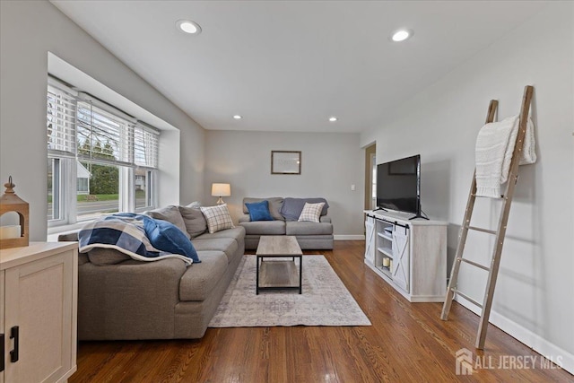 living room featuring dark wood finished floors, recessed lighting, and baseboards