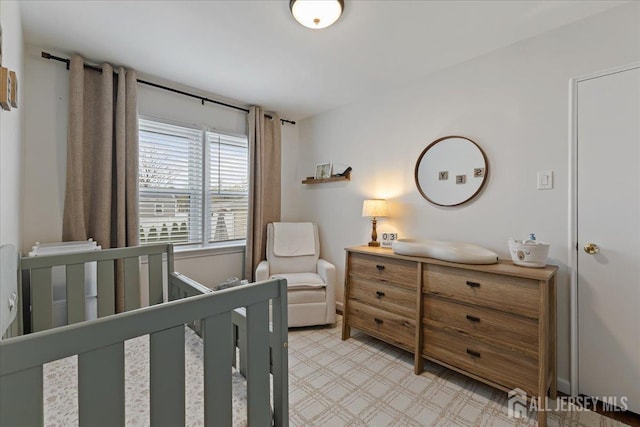 bedroom featuring a crib