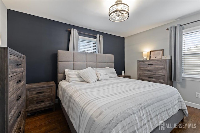 bedroom featuring wood finished floors and baseboards