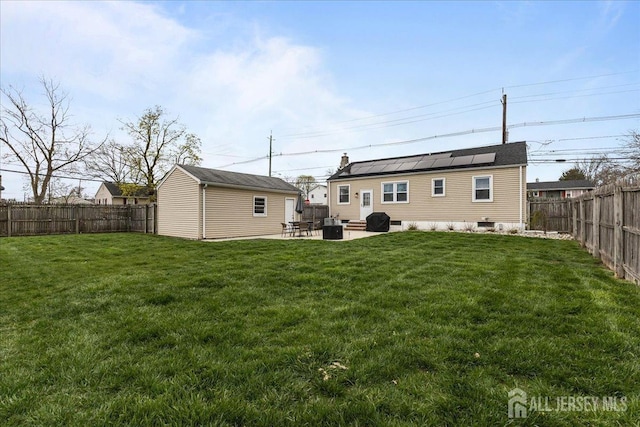 rear view of house with a patio, an outdoor structure, solar panels, and cooling unit