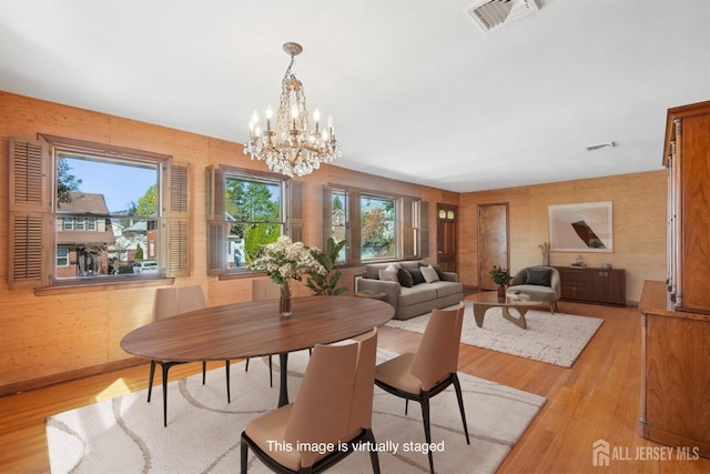 dining room featuring light wood-style flooring and a chandelier