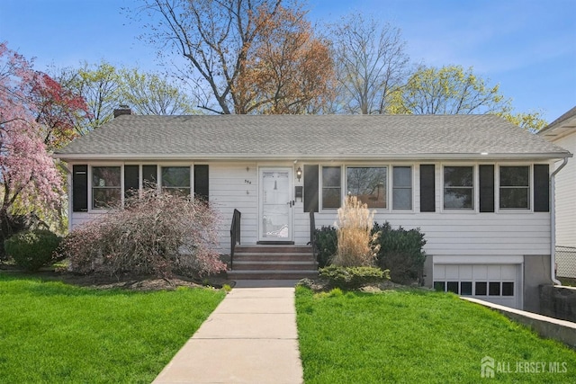 ranch-style home with an attached garage, a front lawn, a chimney, and a shingled roof