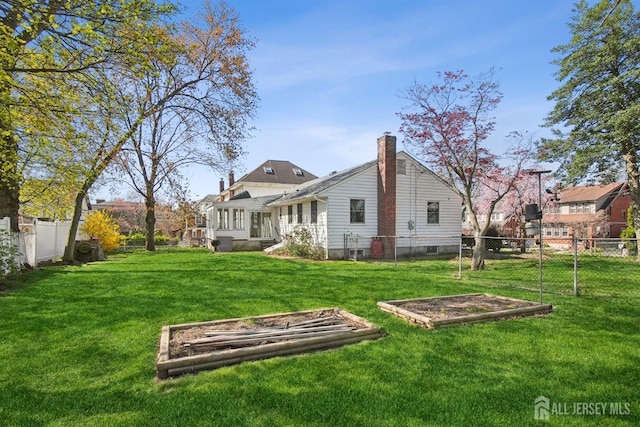 back of property featuring a garden and a chimney