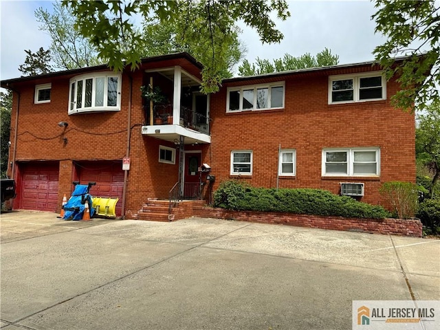 view of front of home featuring concrete driveway, brick siding, and an attached garage