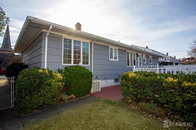 exterior space with a patio, a yard, and central AC