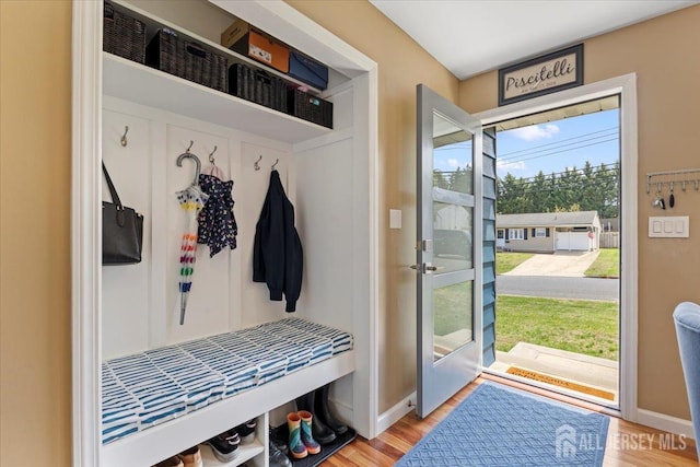mudroom featuring wood finished floors and baseboards