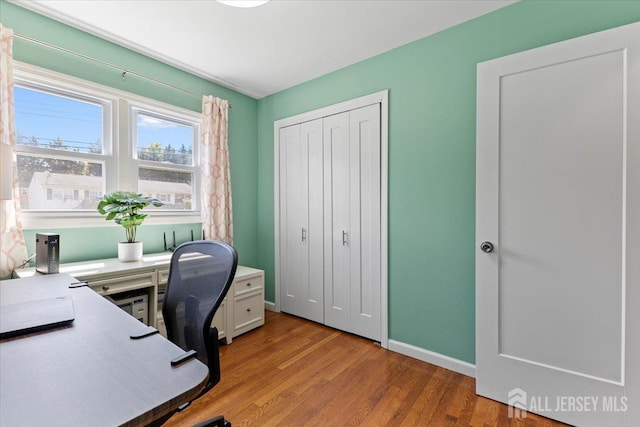 office space with light wood finished floors and baseboards