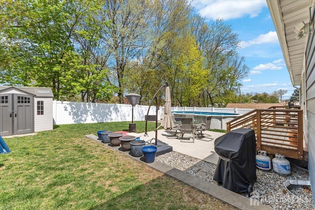 view of yard with a storage shed, a patio area, and an outdoor structure