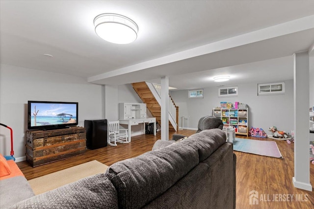 living area featuring stairway, wood finished floors, and baseboards