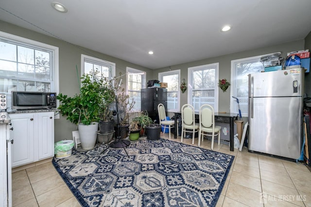 kitchen featuring light tile patterned floors, appliances with stainless steel finishes, white cabinetry, and recessed lighting