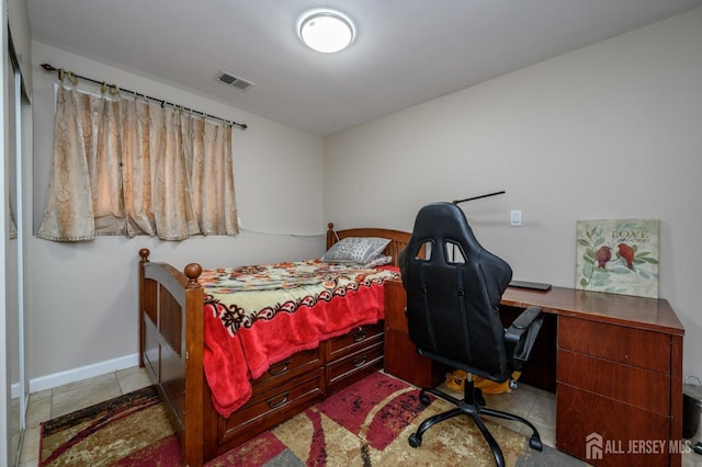 bedroom with tile patterned flooring, visible vents, and baseboards