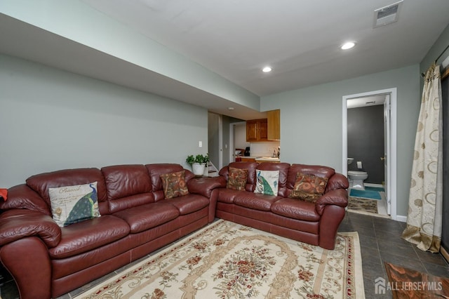 living room featuring baseboards, dark tile patterned floors, visible vents, and recessed lighting