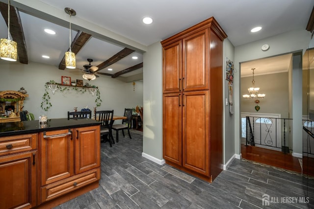 kitchen with baseboards, brown cabinetry, dark countertops, and wood tiled floor