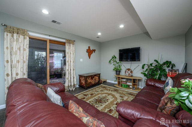 living room featuring baseboards, visible vents, and recessed lighting