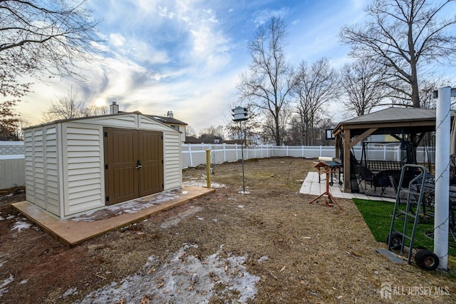 view of shed featuring a gazebo and a fenced backyard