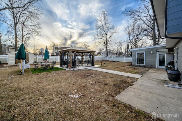 view of yard featuring a gazebo, a patio area, and a fenced backyard