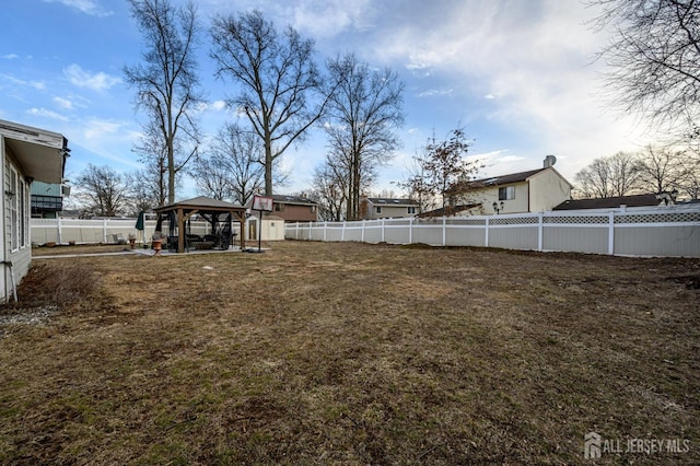 view of yard with a gazebo and a fenced backyard