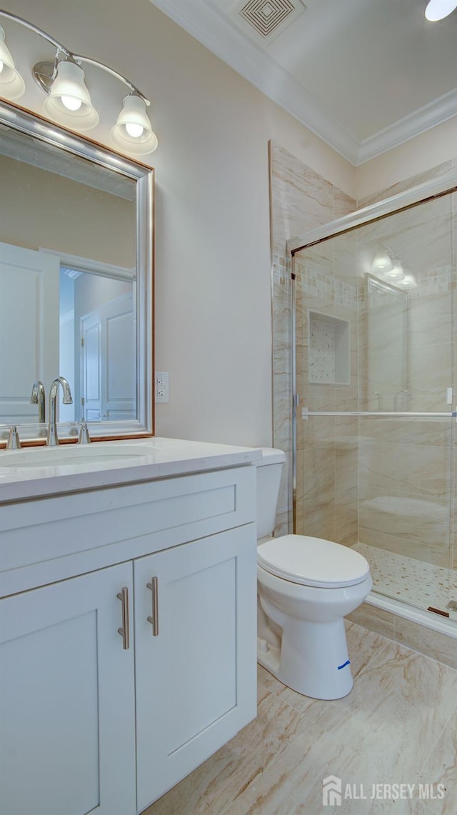 bathroom featuring vanity, toilet, an enclosed shower, and ornamental molding