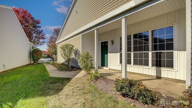 doorway to property with a yard