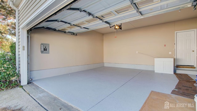 garage featuring electric panel and a garage door opener