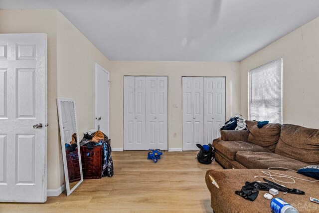 living room with baseboards and light wood finished floors