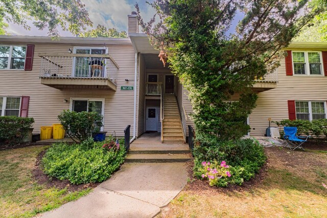 view of front of house featuring a balcony