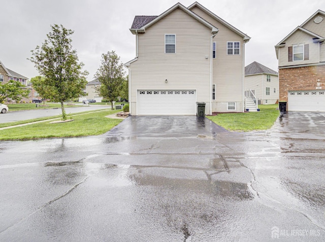 221 Morning Glory Dr, Monroe, NJ 08831 - view of side of home featuring driveway, a lawn, and an attached garage