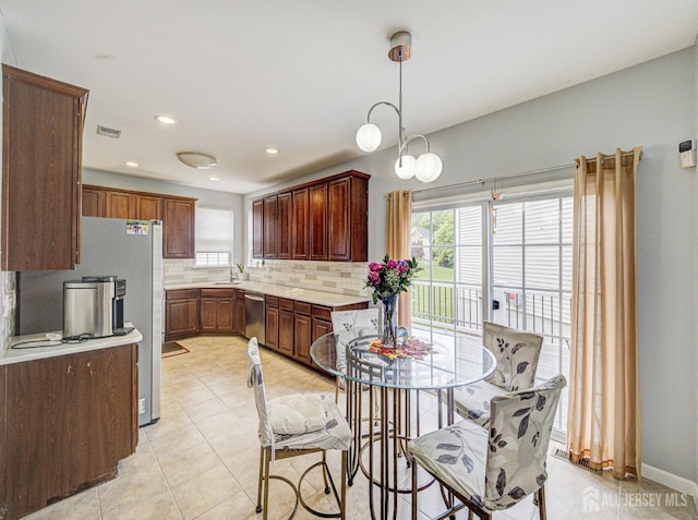 221 Morning Glory Dr, Monroe, NJ 08831 - kitchen featuring stainless steel appliances, light countertops, tasteful backsplash, light tile patterned floors, and a sink
