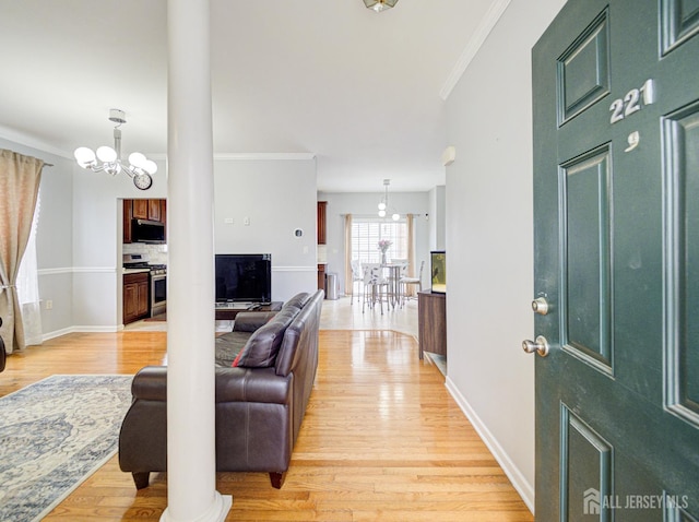 221 Morning Glory Dr, Monroe, NJ 08831 - living room with a chandelier, light wood-type flooring, ornamental molding, baseboards, and ornate columns
