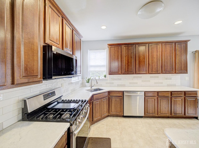 221 Morning Glory Dr, Monroe, NJ 08831 - kitchen with appliances with stainless steel finishes, a sink, light countertops, decorative backsplash, and recessed lighting