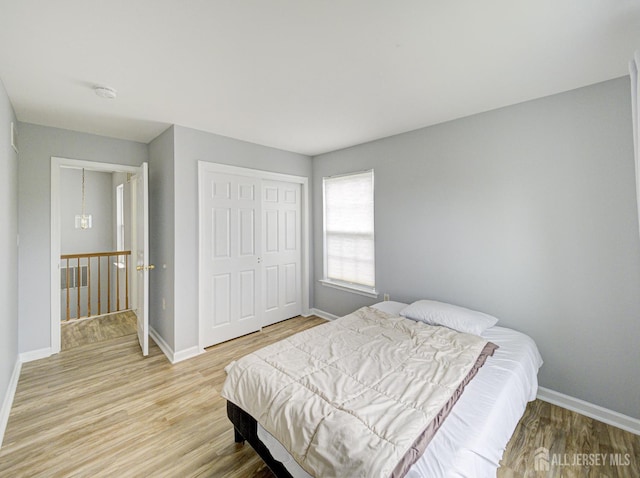 221 Morning Glory Dr, Monroe, NJ 08831 - bedroom with light wood-style flooring, baseboards, and a closet