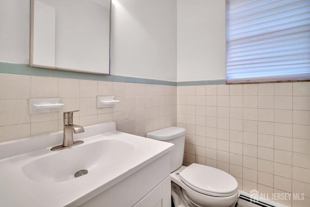 402 N Cranbury Rd Unit 8, East Brunswick, NJ 08816 - half bath featuring a baseboard heating unit, tile walls, vanity, and wainscoting