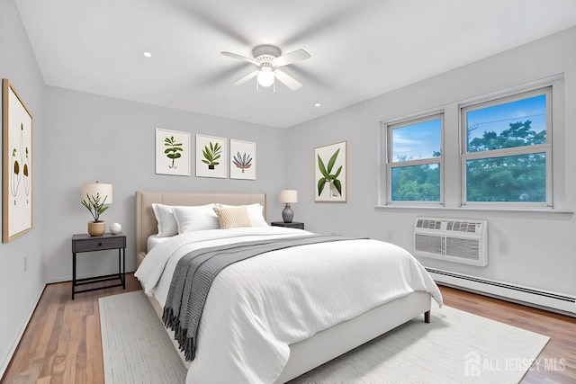 402 N Cranbury Rd Unit 8, East Brunswick, NJ 08816 - bedroom with wood finished floors, a wall mounted AC, a baseboard radiator, a ceiling fan, and recessed lighting